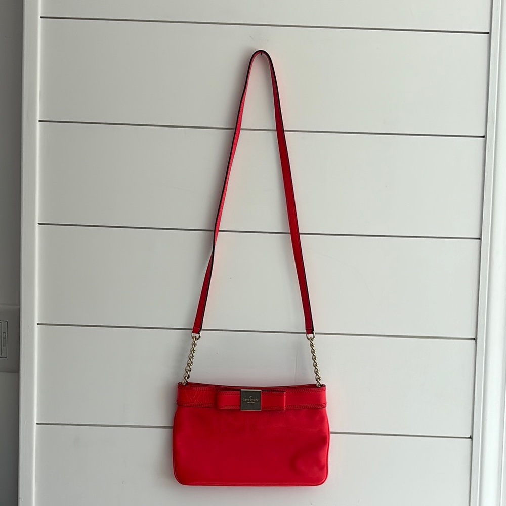 Neon orange Kate Spade crossbody bag.